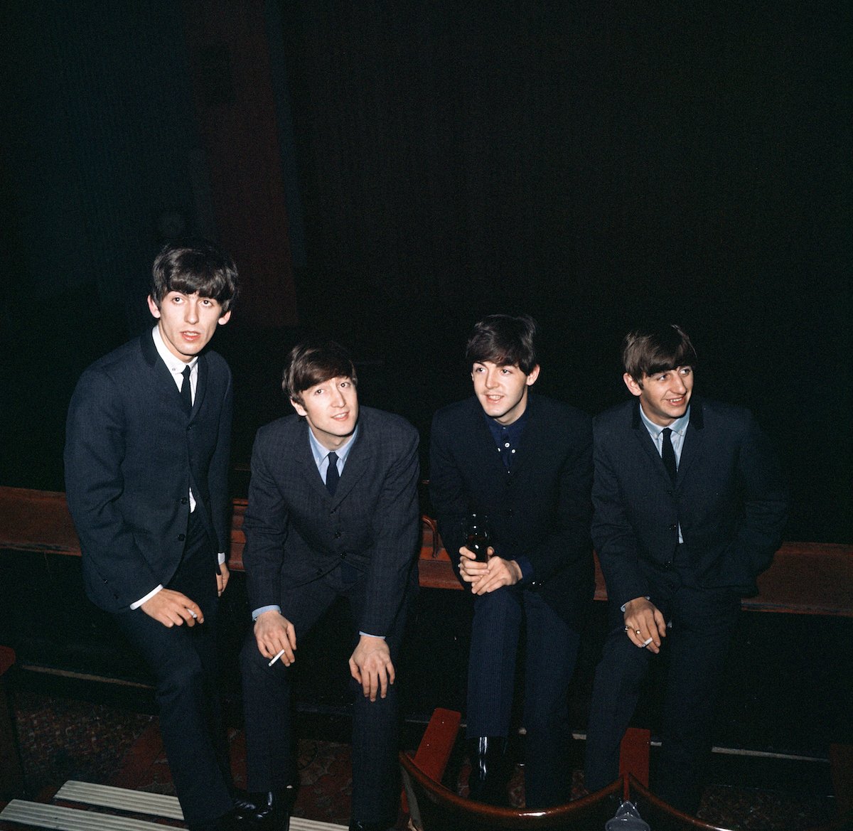 The Beatles put their hands on their knees