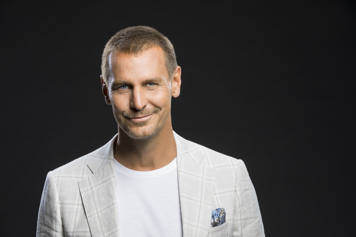 'The Bold and the Beautiful' star Ingo Rademacher wearing a light blue suit and posing in front of a black backdrop.