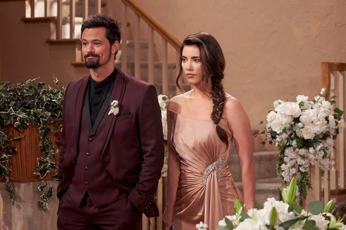 'The Bold and the Beautiful' star Matthew Atkinson in a burgundy suit and Jacqueline MacInnes Wood in a champagne dress; standing in the Forrester mansion.