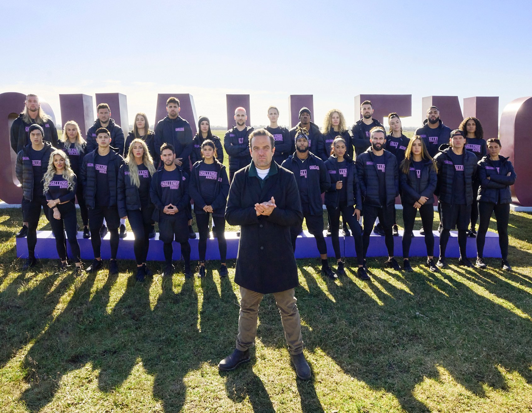 Kaycee and Kenny Clark posing alongside 'The Challenge 38' cast for group photo