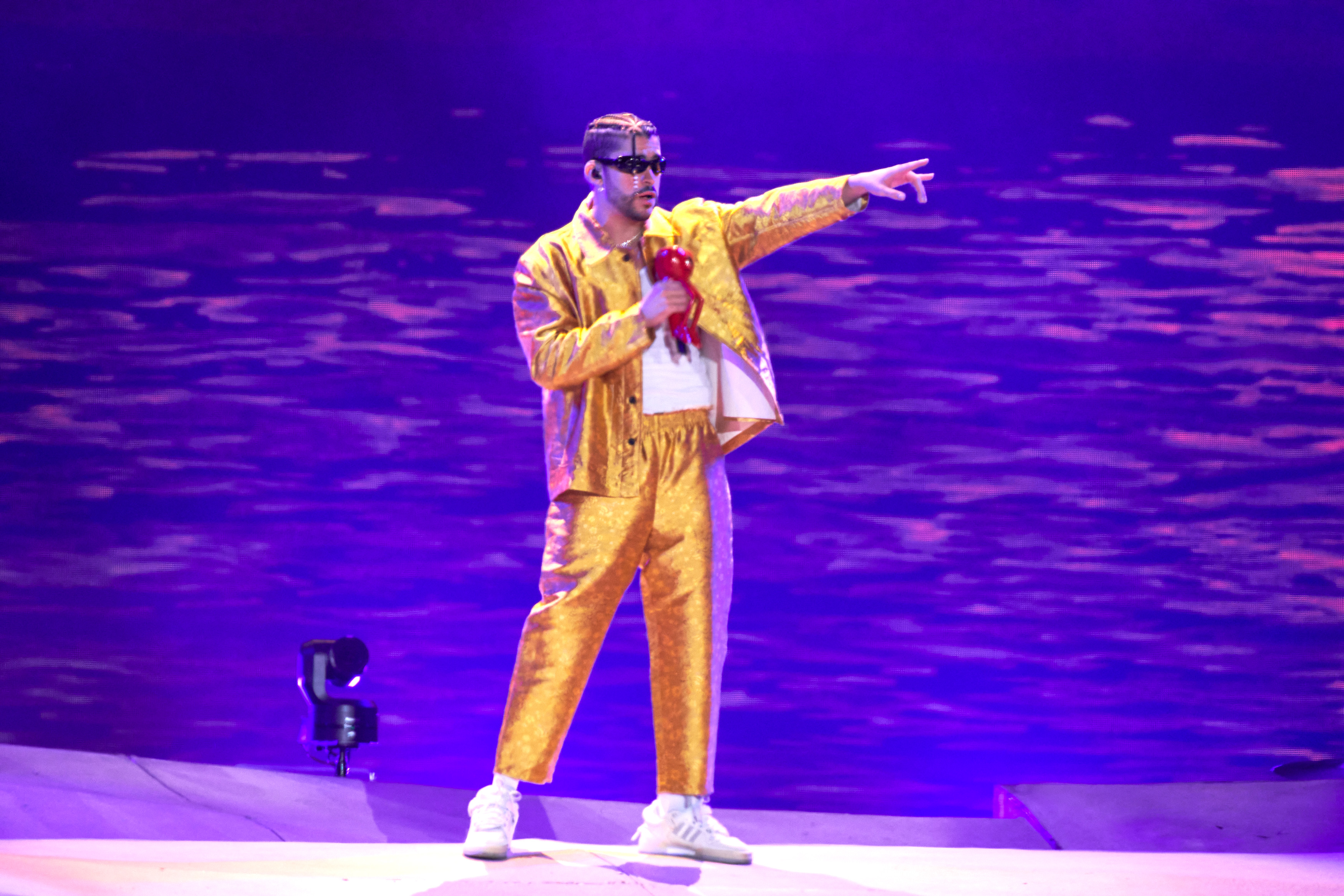 Entertainer Bad Bunny, right, attends during the first half of an