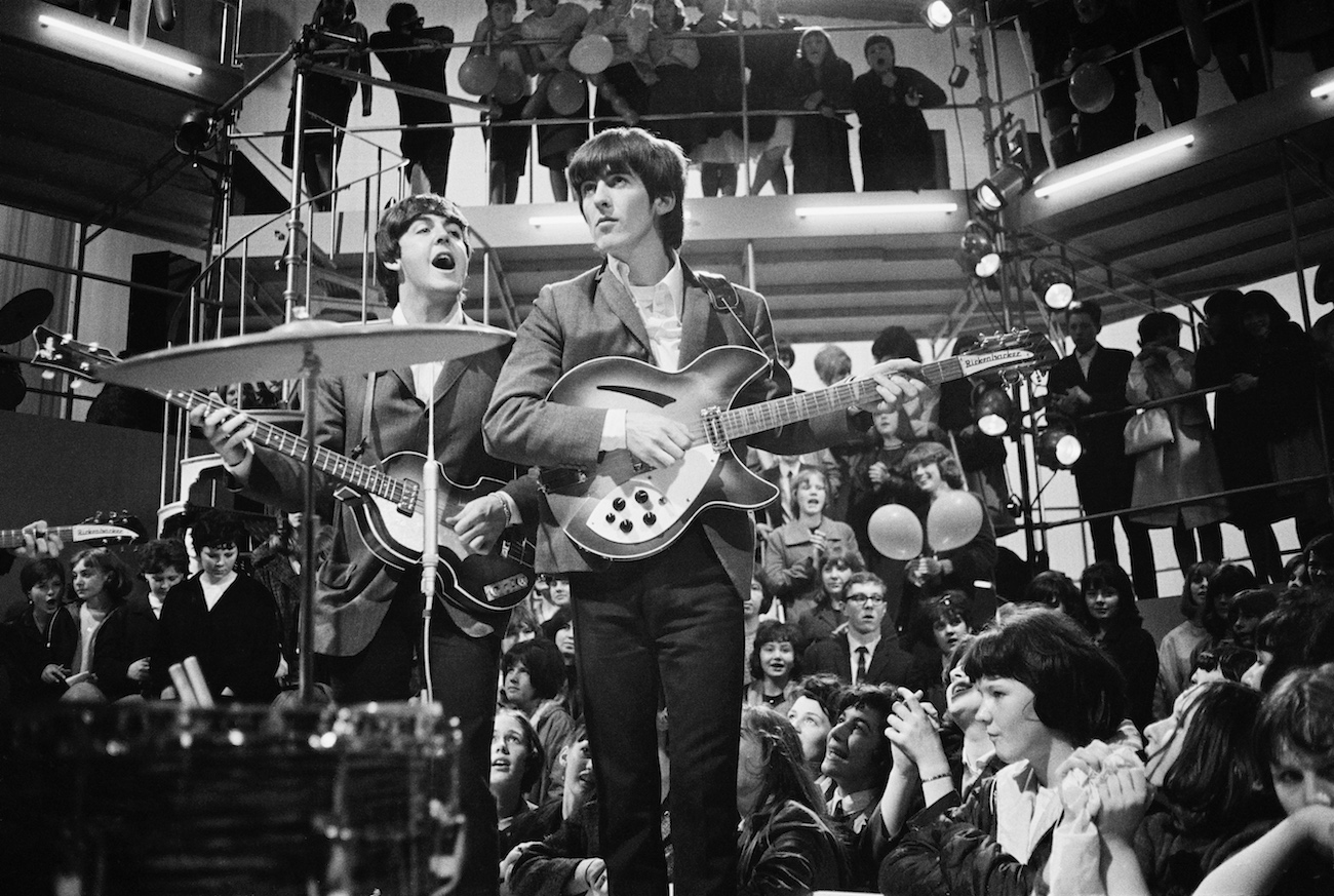 George Harrison performing with The Beatles in London, 1964.