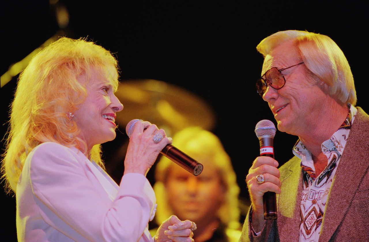 Tammy Wynette and George Jones pictured performing live on stage together at Hammersmith Apollo in London in September 1995.