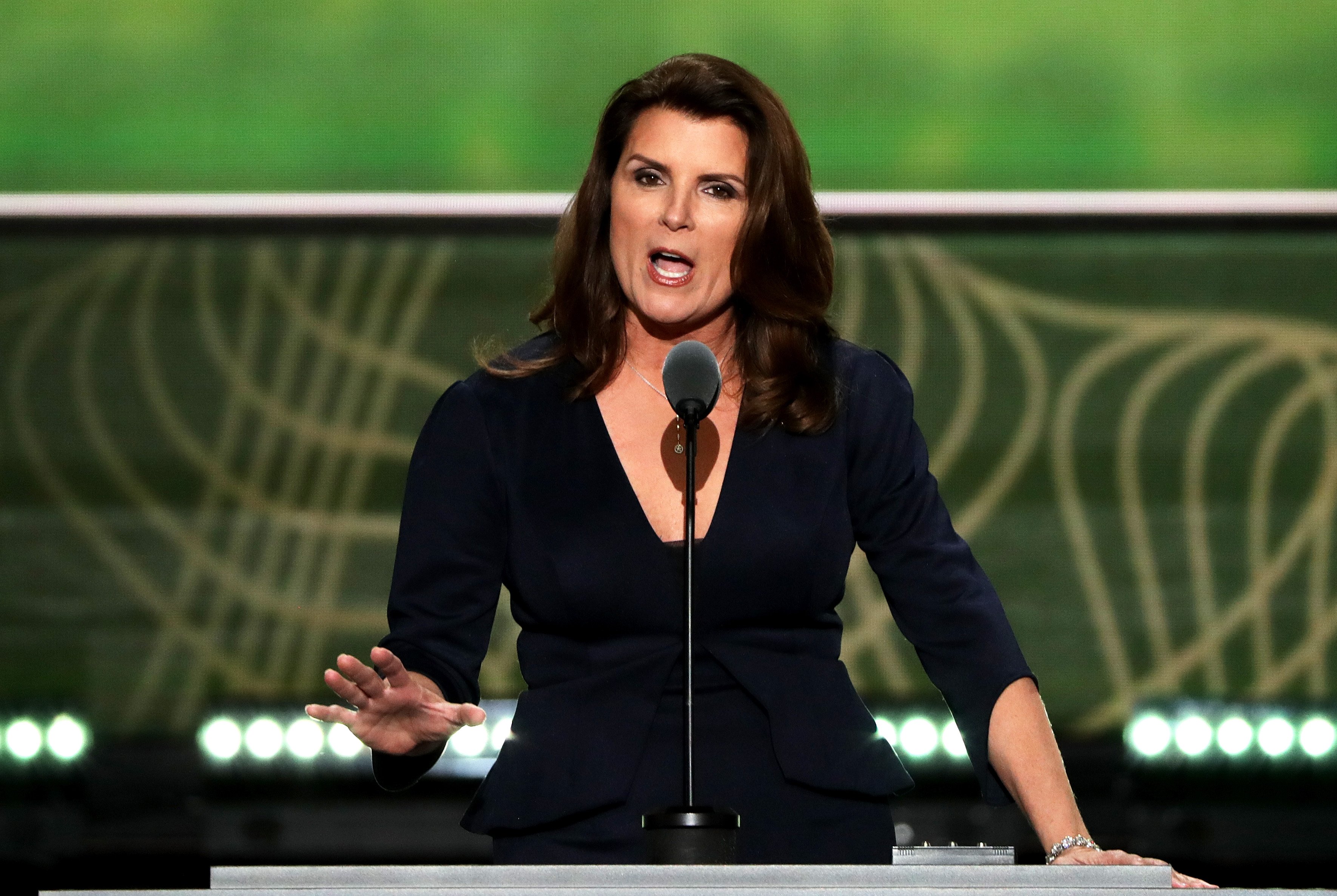 'The Bold and the Beautiful' star Kimberlin Brown wearing a Navy blue dress and speaking into a microphone.