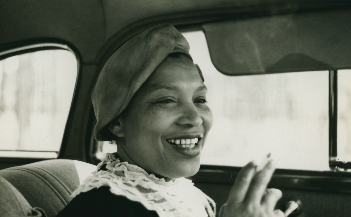 Zora Neale Hurston smiling in a car