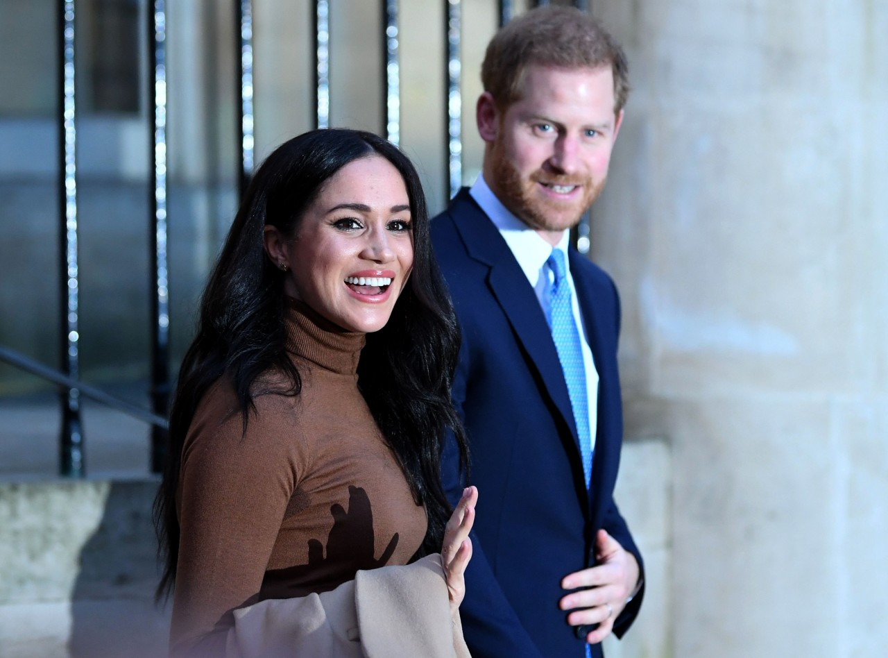 Meghan Markle and Prince Harry walk together after their visit to Canada House. 