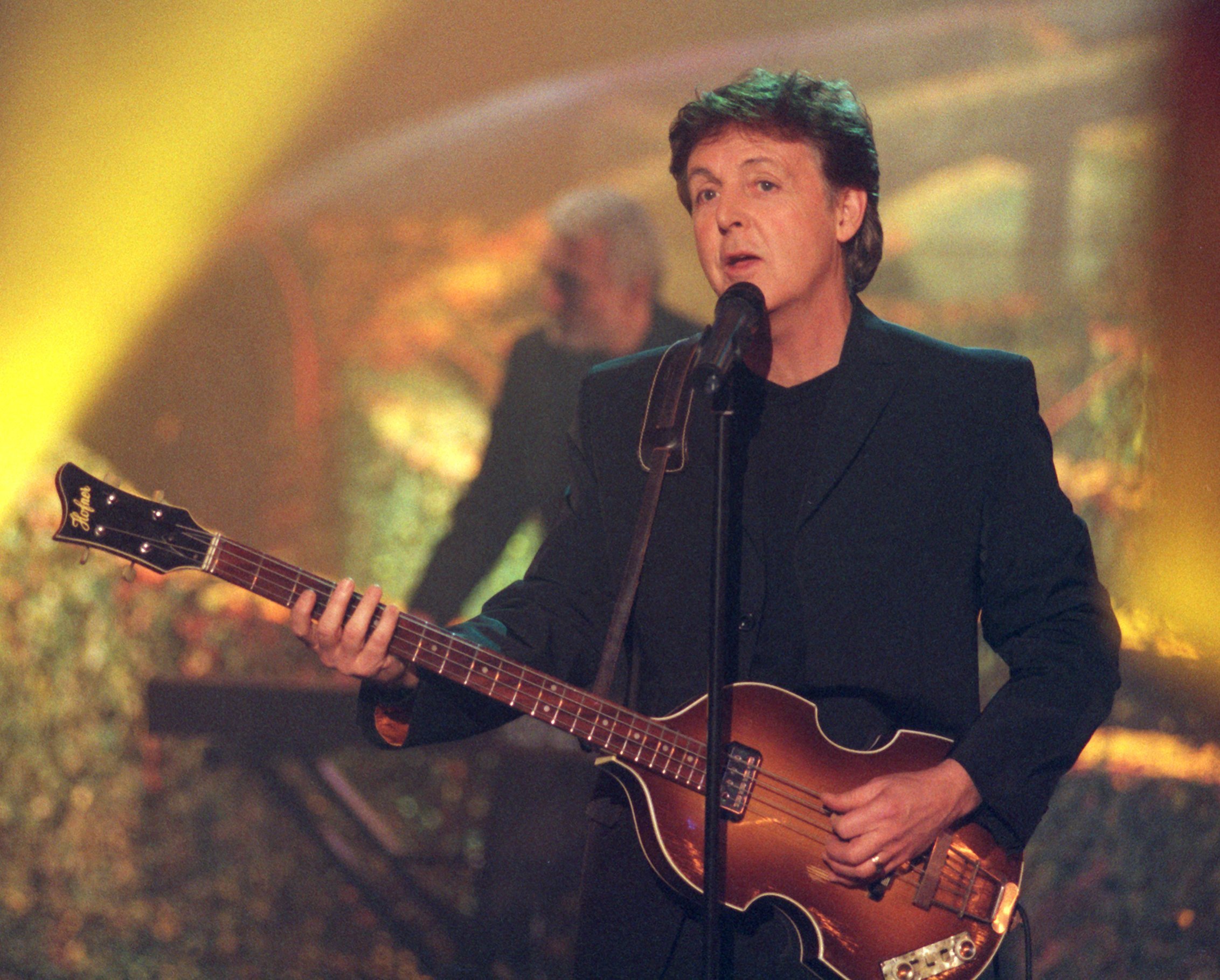 "Maybe I'm Amazed" singer Paul McCartney with a guitar