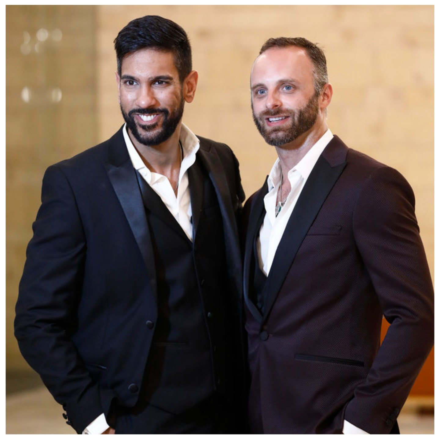 Amrit Kapai and Nicholas Kouchoukos from 'Family Karma' smile wearing tuxes