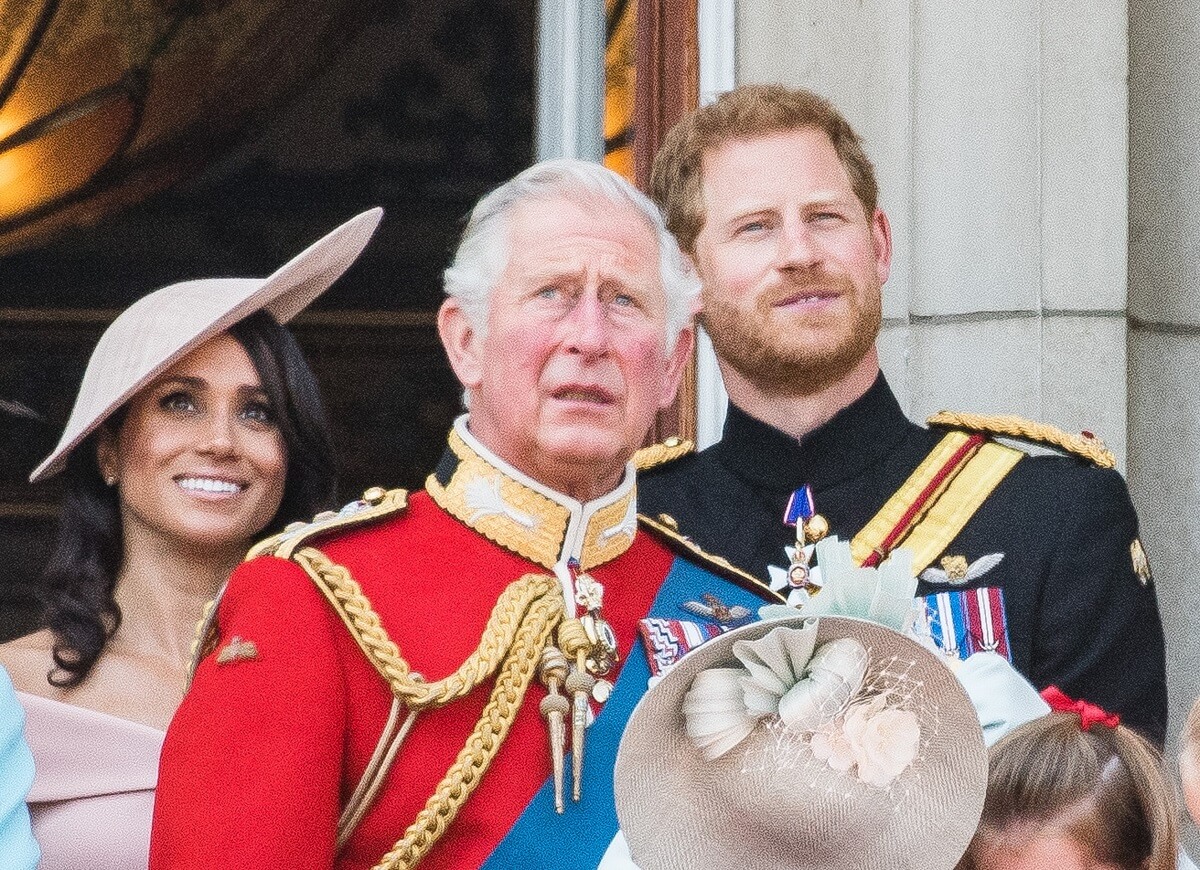 Meghan Markle, now-King Charles II, and Prince Harry standing on the balcony of Buckingham Palace during Trooping The Colour 2018