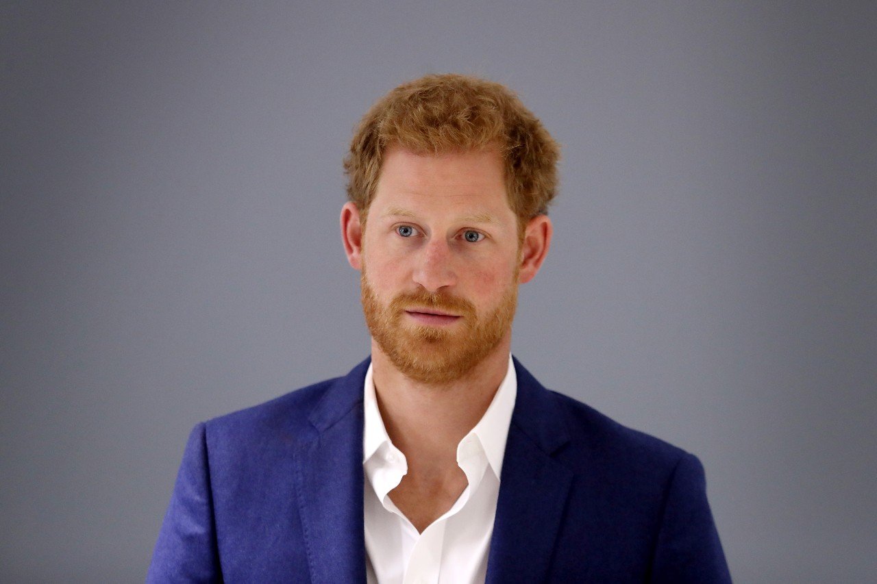 Prince Harry poses in a blue suit. 