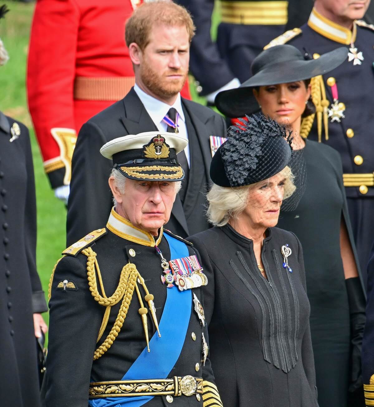 Prince Harry, Meghan Markle, King Charles III, and Camilla Parker Bowles observe Queen Elizabeth II's coffin transferred from the gun carriage to the hearse