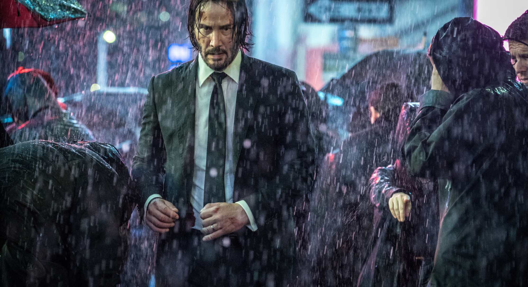 'John Wick_ Chapter 3 – Parabellum' Keanu Reeves as John Wick walking through the rain in a suit in a crowd of people