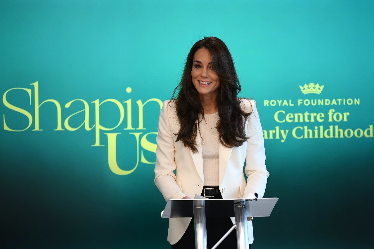 Kate Middleton wears a white blazer and top during a presentation for the Royal Foundation Center for Early Childhood 