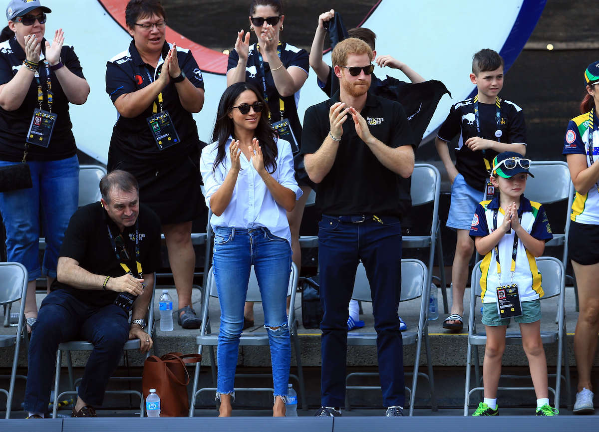 Meghan Markle and Prince Harry, who thought a statement defending Meghan Markle from the palace might've helped after their first public appearance at the 2017 Invictus Games, clap