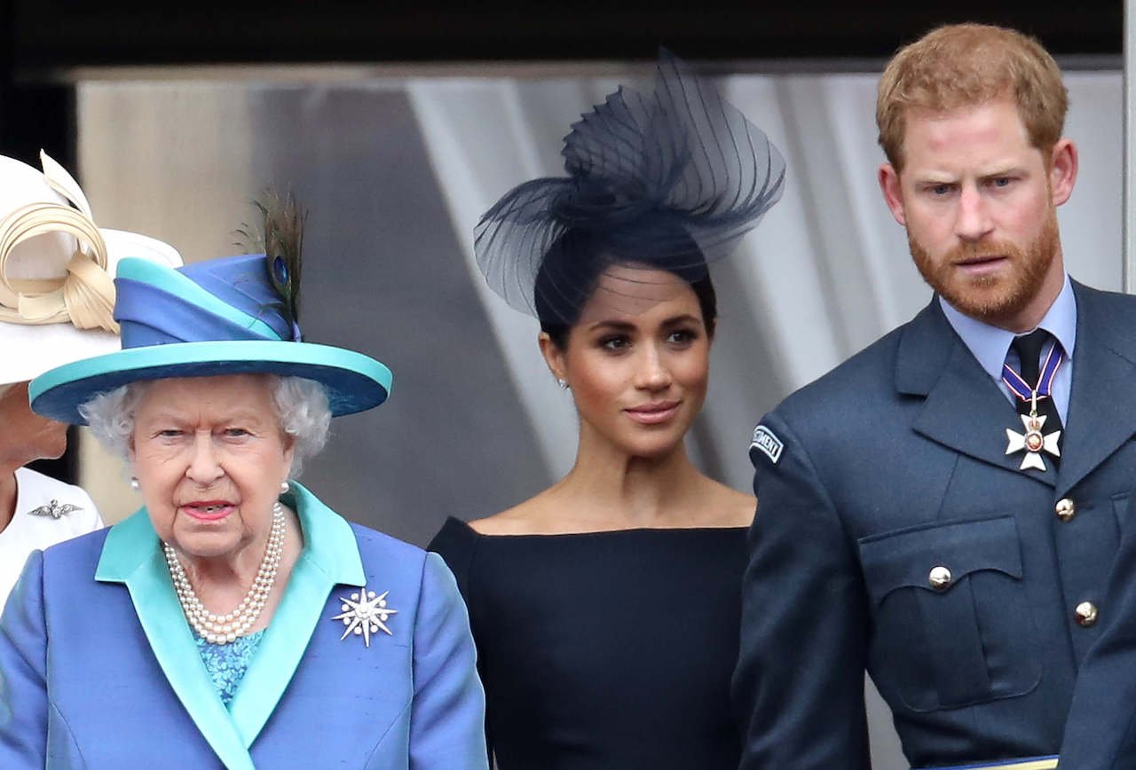 Queen Elizabeth, Meghan Markle, and Prince Harry on the balcony of Buckingham Palace in 2018.