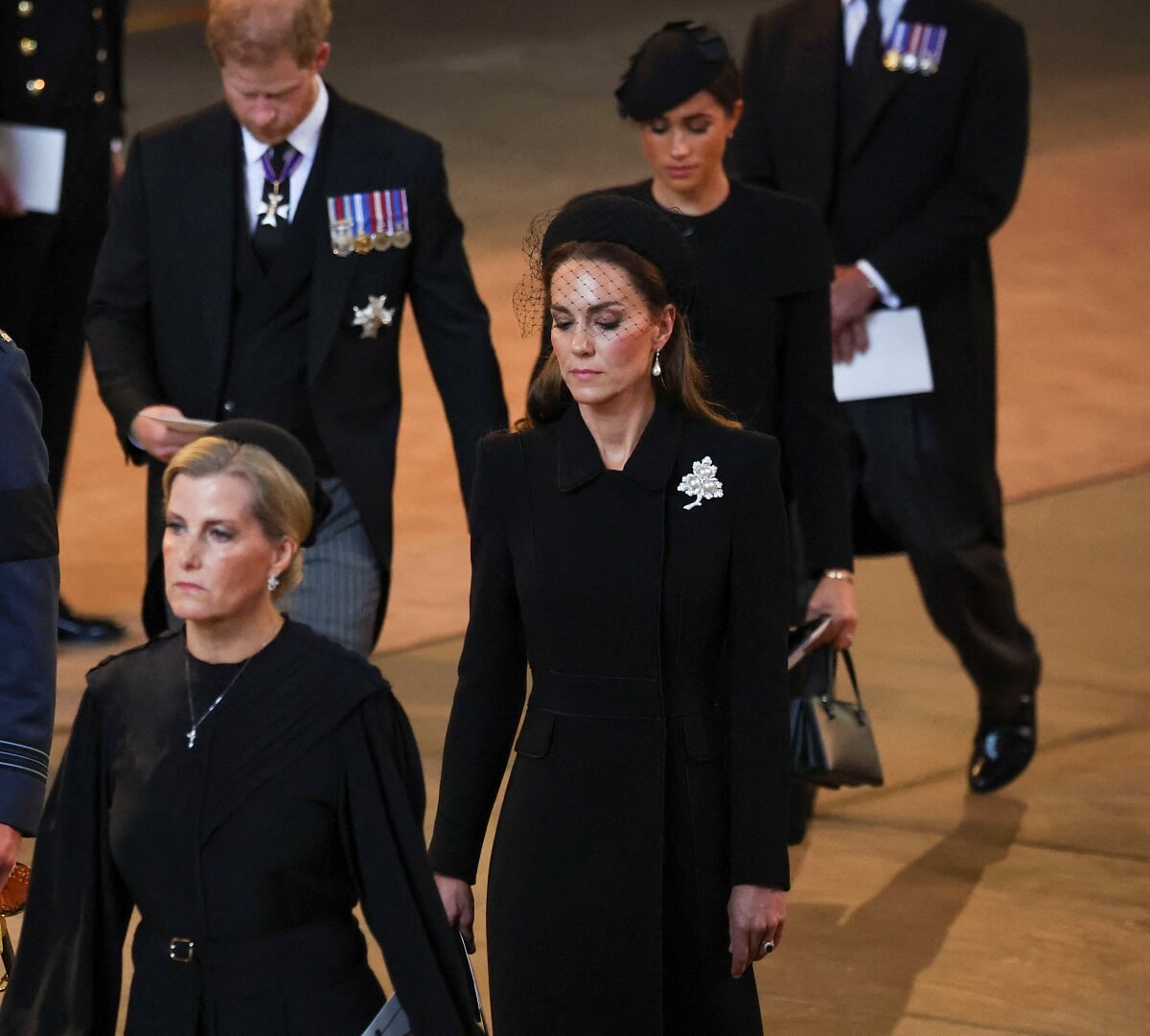 Members of the royal family walk in a procession with the coffin of Queen Elizabeth as it arrives at Westminster Hall