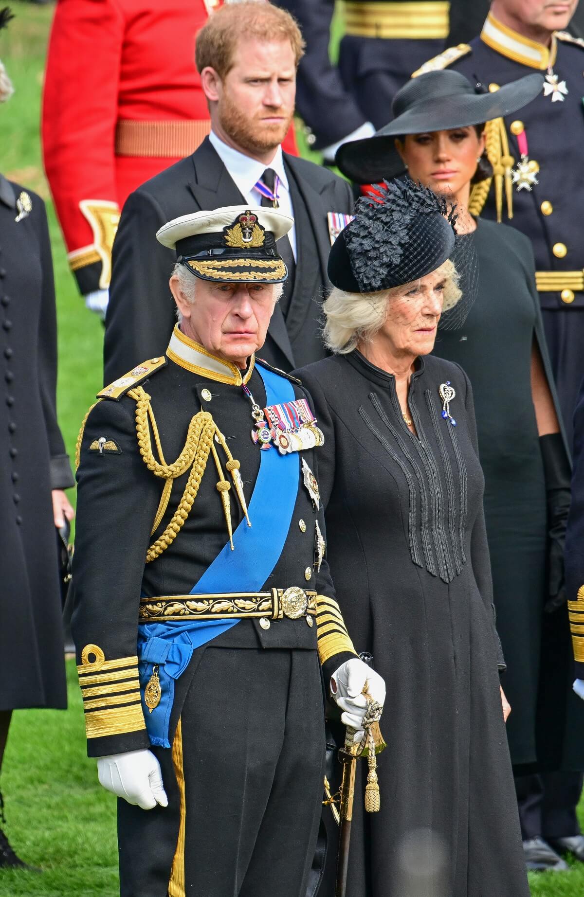 Prince Harry, Meghan Markle, King Charles III and Camilla Parker Bowles observe the coffin of Queen Elizabeth II as it is transferred from the gun carriage
