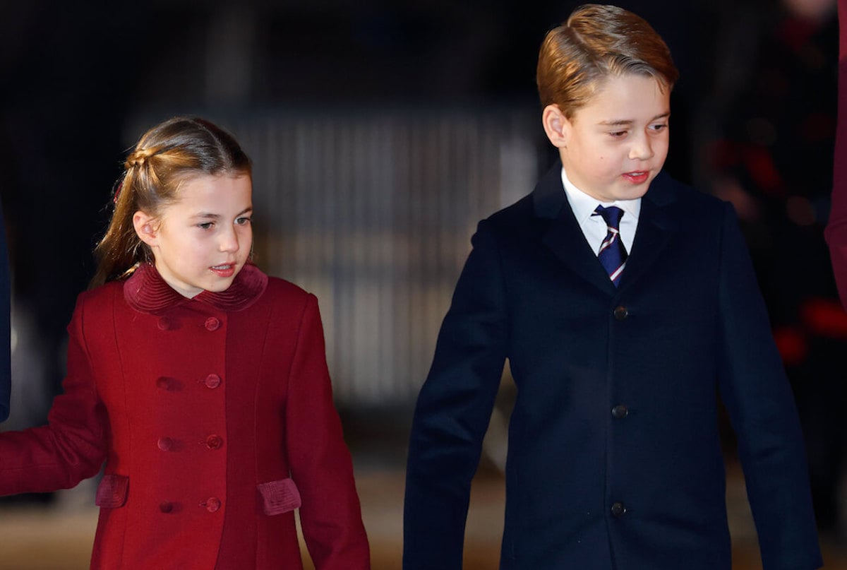 Princess Charlotte, whom a royal authors says is like Princess Anne, walks with Prince George