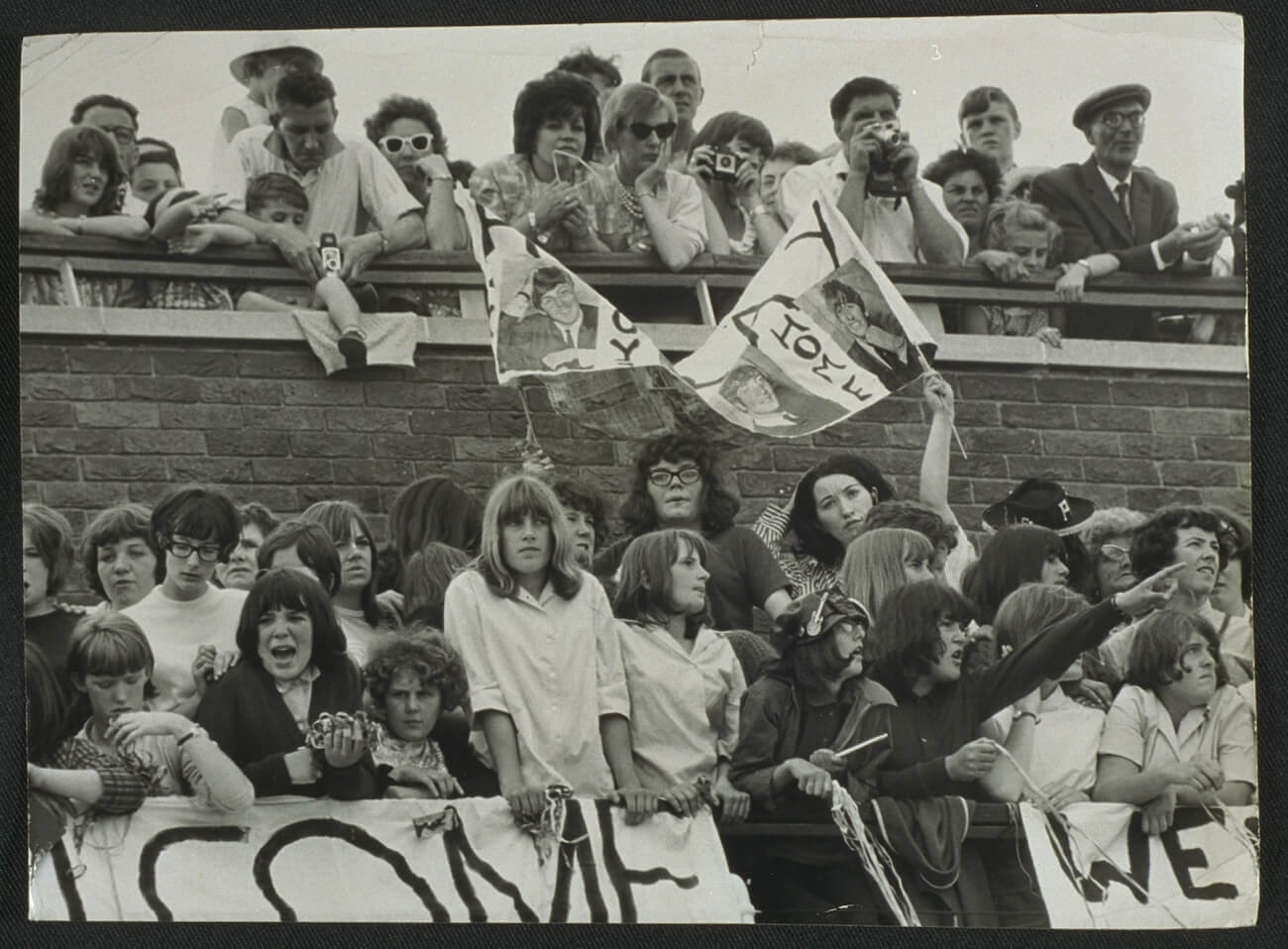 Fans waiting for The Beatles to arrive home in England in 1964.