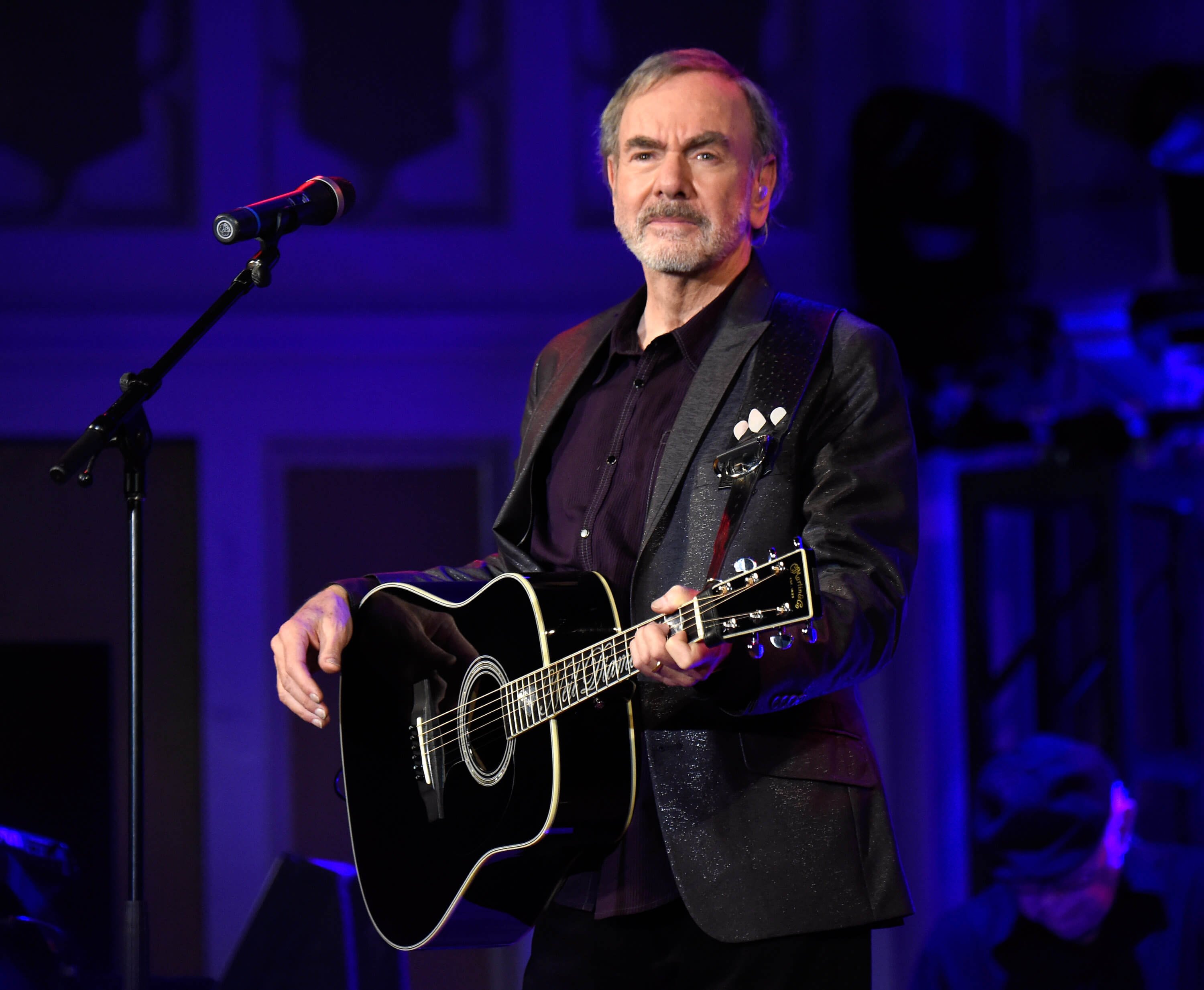 "Sweet Caroline" singer Neil Diamond with a guitar