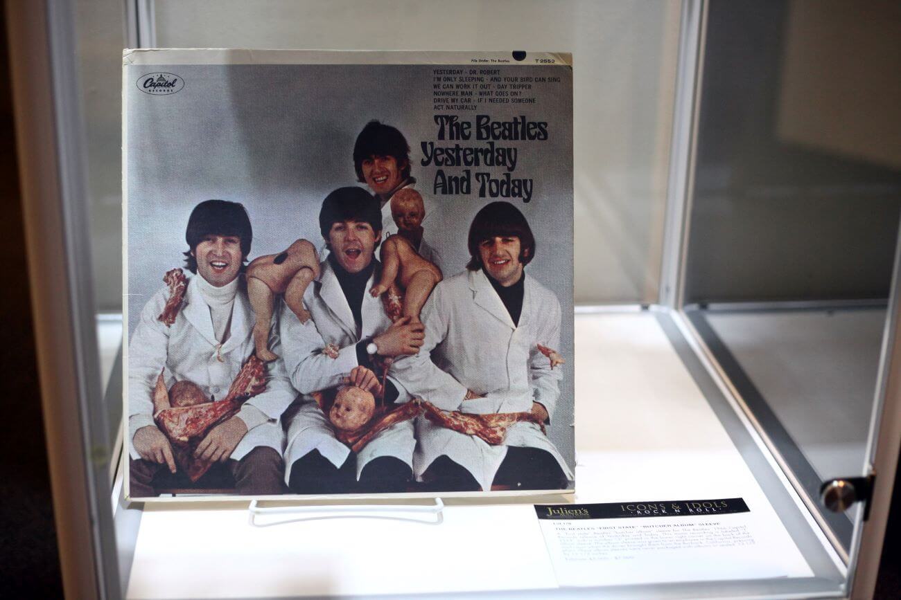 The Beatles' Butcher cover sits in a glass case.