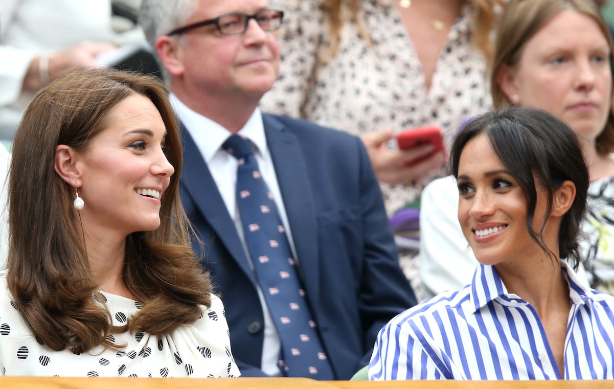 Kate Middleton and Meghan Markle smile and chat at Wimbledon in 2018