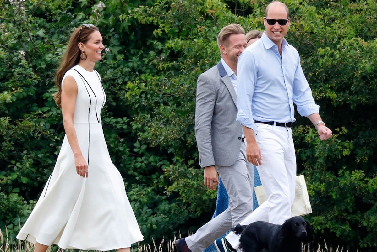 Kate Middleton, whose 'impatience is clear' as she pet rescue dogs in Wales, walks with Prince William and their dog, Orla