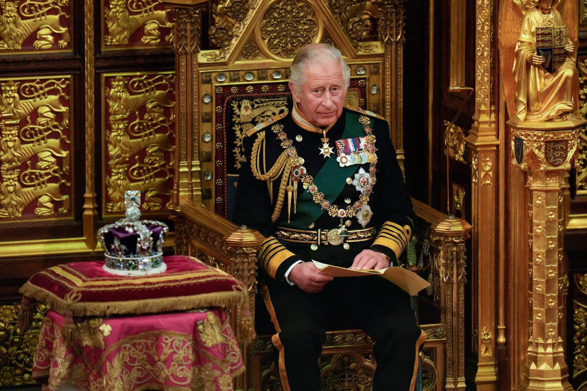 King Charles, then the Prince of Wales reads the Queen's speech next to her Imperial State Crown in the House of Lords Chamber, during the State Opening of Parliament in the House of Lords at the Palace of Westminster on May 10, 2022 in London, England