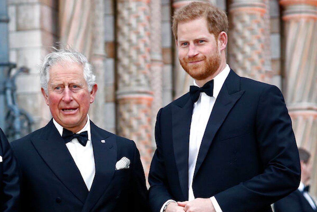 King Charles, who appeared with Prince Harry and Meghan Markle in a souvenir coronation program photo, taken in 2018, stands with Prince Harry