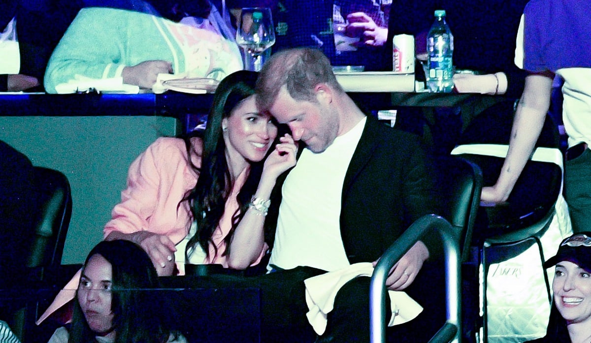 Meghan Markle leans in to talk to Prince Harry during a game between the Los Angeles Lakers and the Memphis Grizzlies