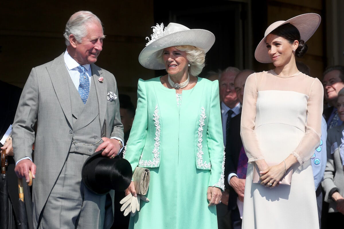 Meghan Markle, who will want to look 'busy and unavailable' coronation weekend, with King Charles and Camilla Parker Bowles