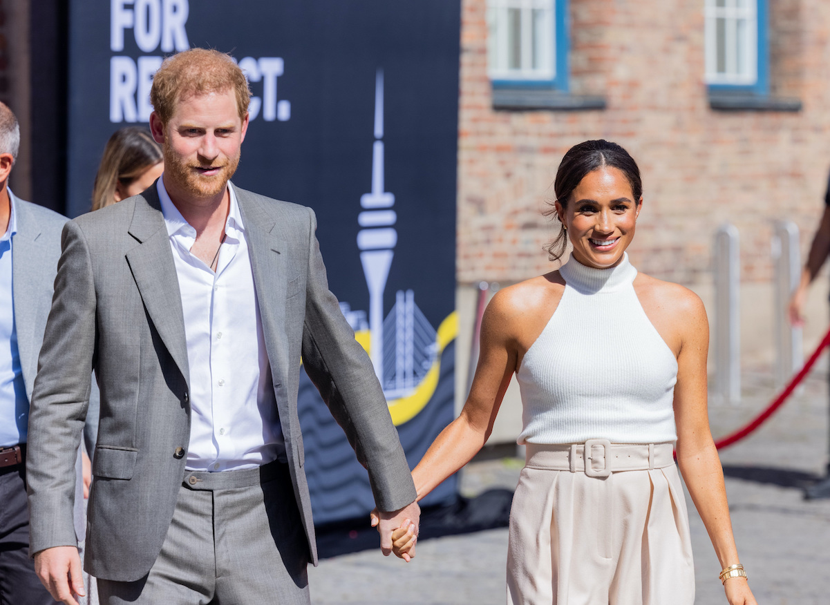 Prince Harry and Meghan Markle hold hands in 2022