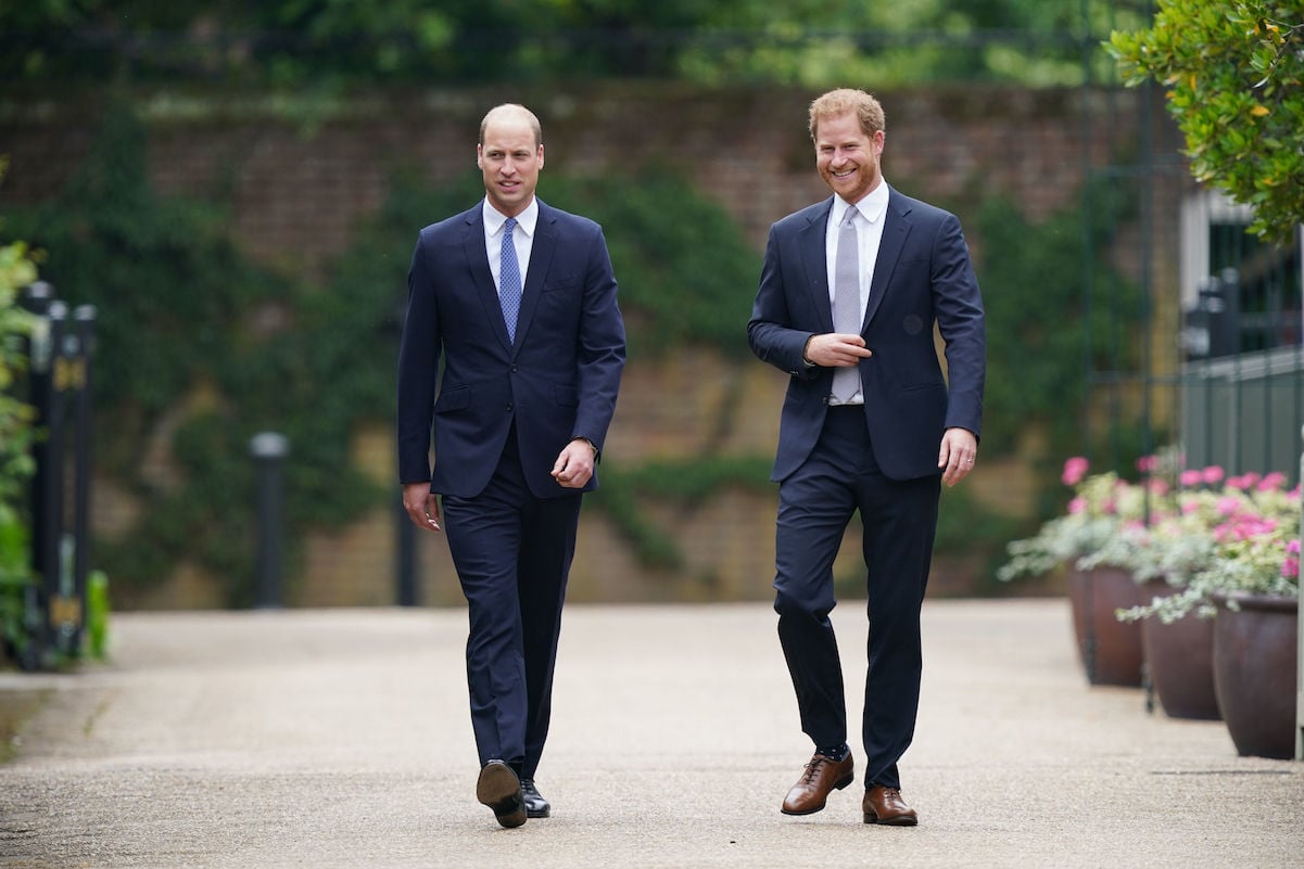 Prince Harry Prince William walking together wearing suits