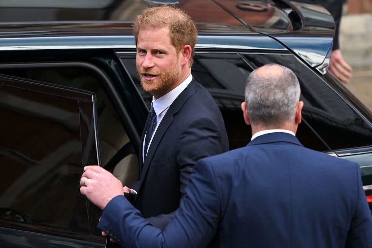 Prince Harry, who will be 'exposed' at the coronation without Meghan Markle, climbs in a car