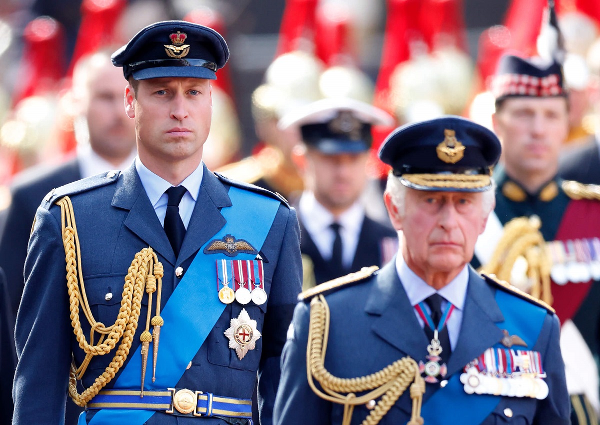 Prince William and King Charles III, who may be at odds of Harry's quick coronation trip, walk behind Queen Elizabeth II's coffin as it's transported from Buckingham Palace