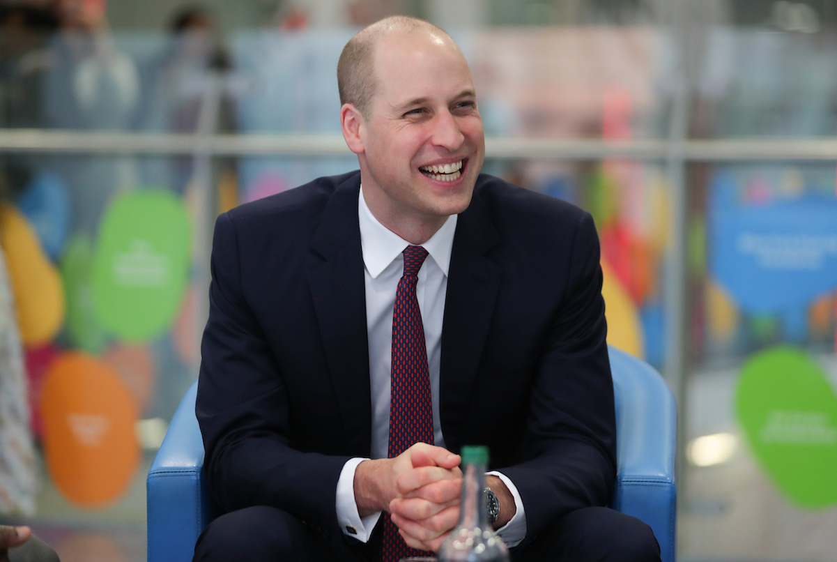 Prince William smiling with hands cupped