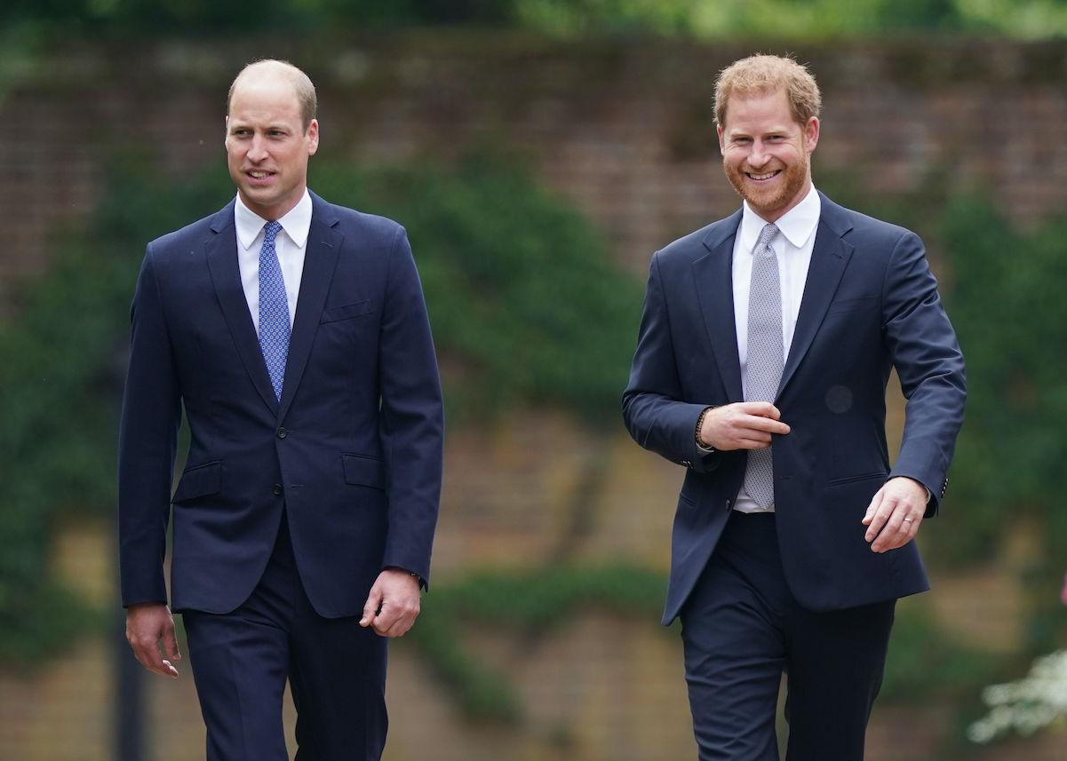 Prince William Prince Harry walking wearing suits