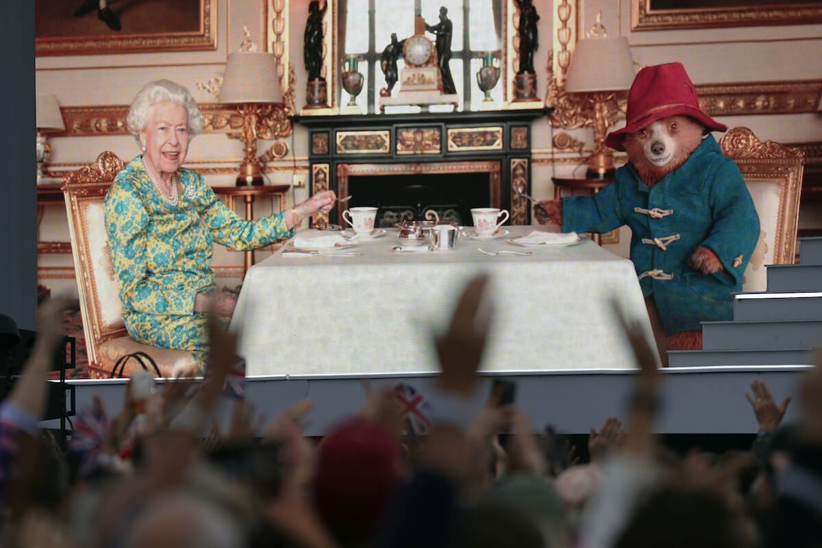 Queen Elizabeth II, who had no 'easy task' in the Paddington Bear video, has tea with the fictional character.