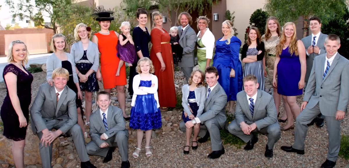 The Brown family, in happier times pose for a photo in front of their Las Vegas homes. Robyn Brown and Kody Brown now have a monogamous marriage