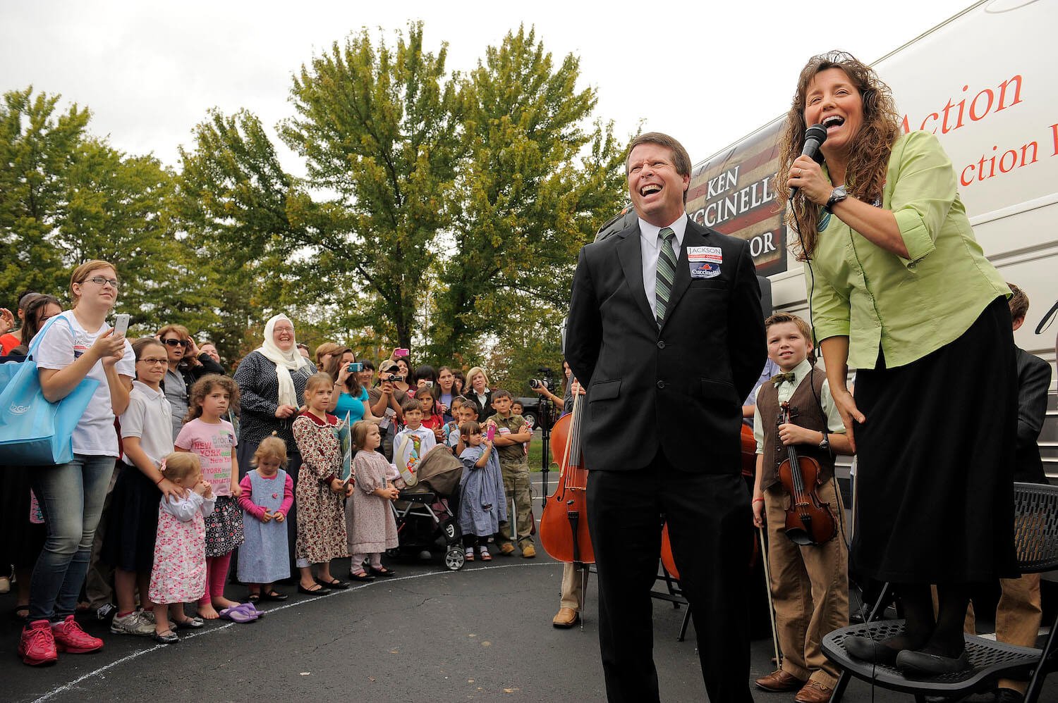 Jim Bob Duggar and Michelle Duggar of the Duggar family standing outside and speaking to a crowd