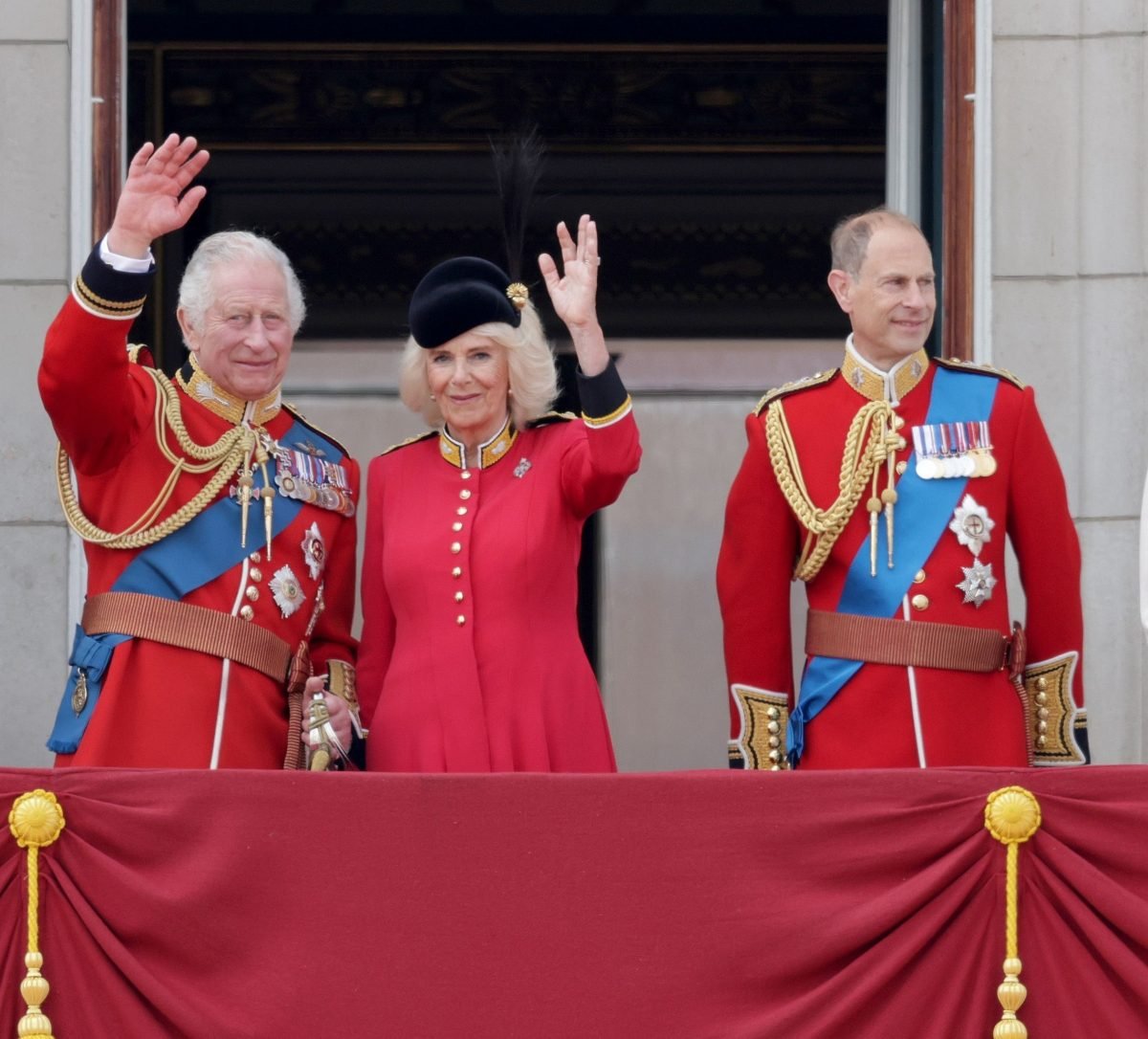 King Charles III, Camilla Parker Bowles (now Queen Camilla) and Prince Edward stand on the balcony of Buckingham Palace to watch a flypast