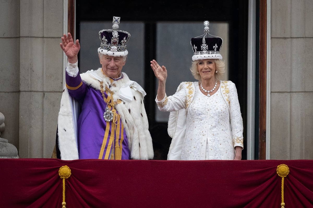 King Charles III and Queen Camilla are seen on the Buckingham Palace balcony during the flypast following the coronation ceremony