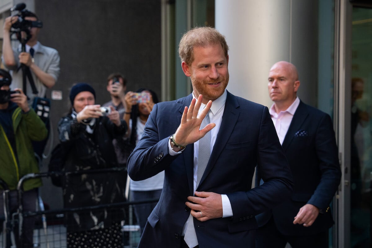 Prince Harry, whom a royal expert says could have a royal reconciliation without Meghan Markle, waves