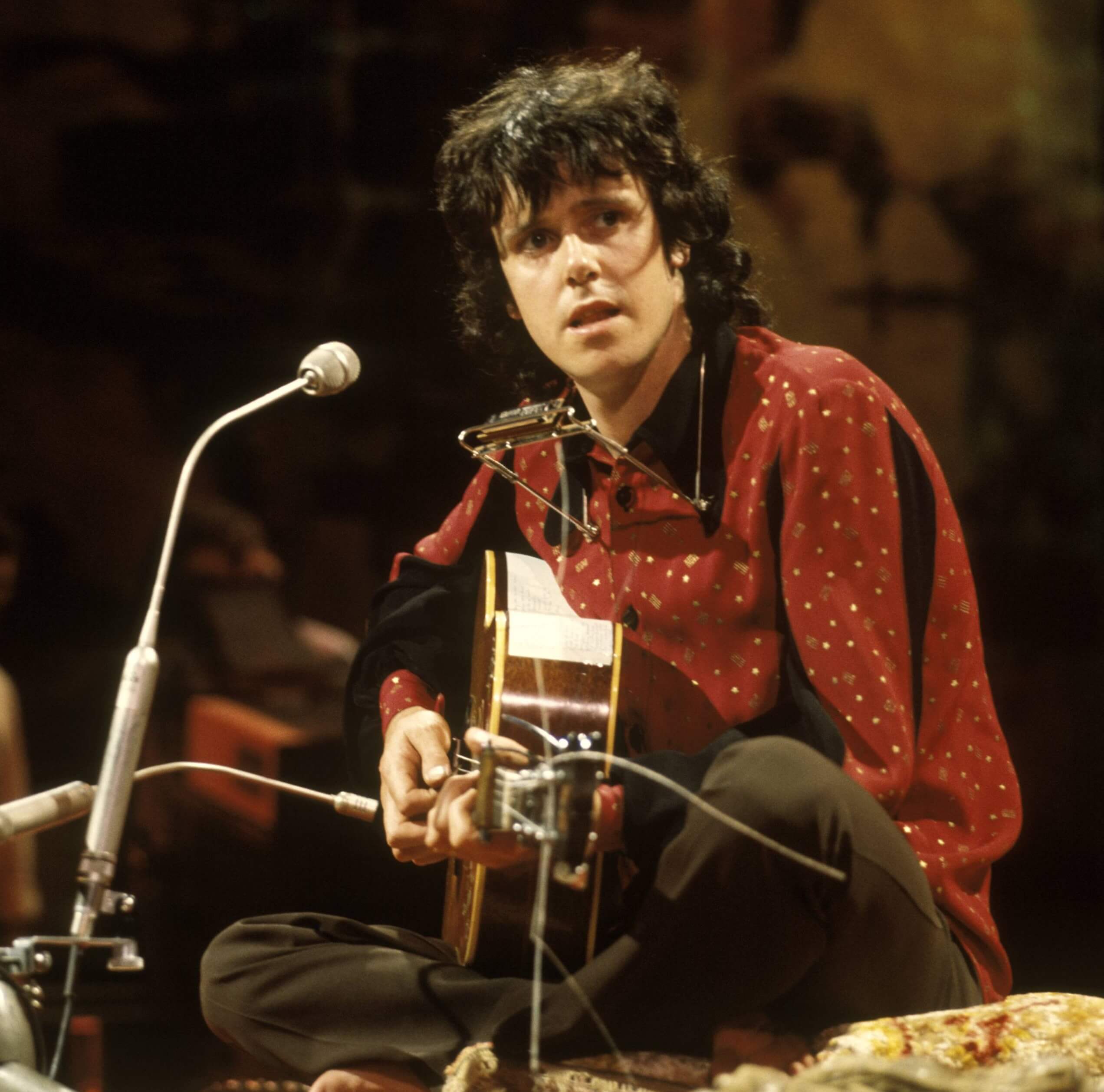 Donovan, a friend of The Beatles, with a guitar