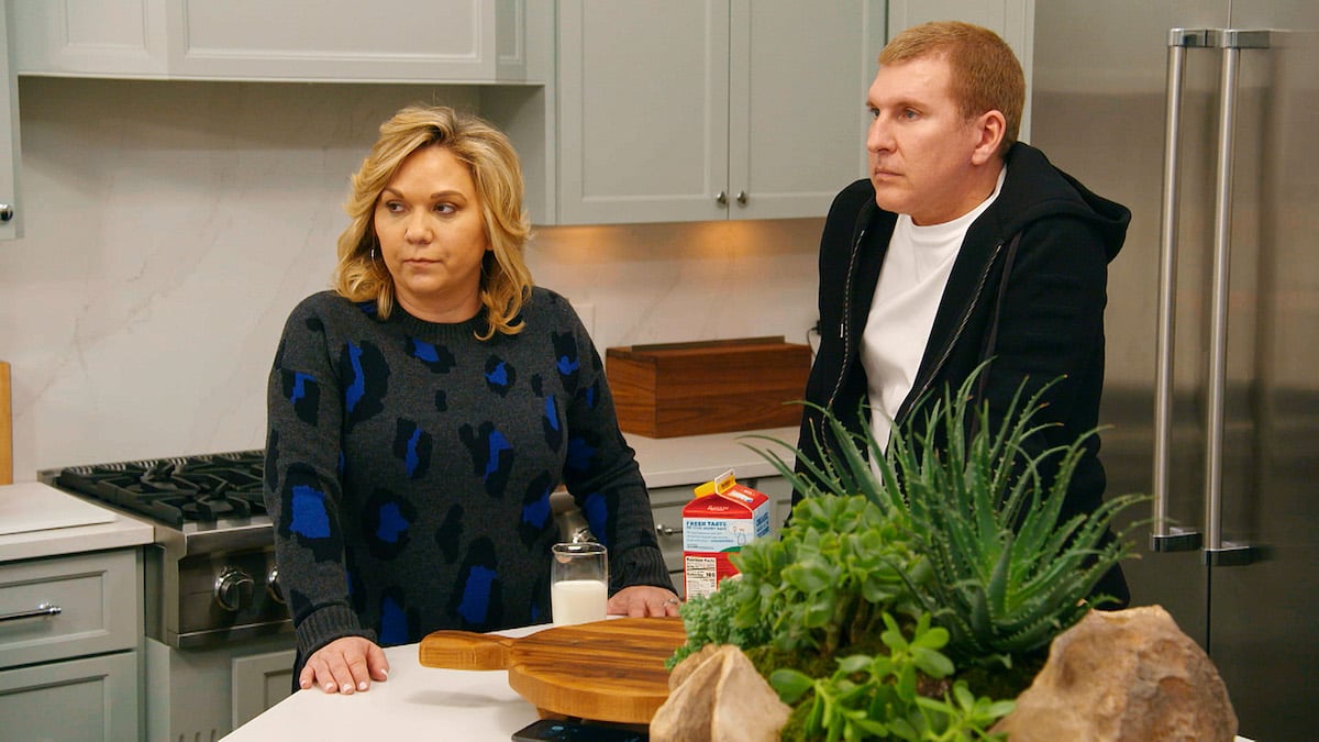 Julie Chrisley and Todd Chrisley standing in a kitchen in an episode of 'Chrisley Knows Best'