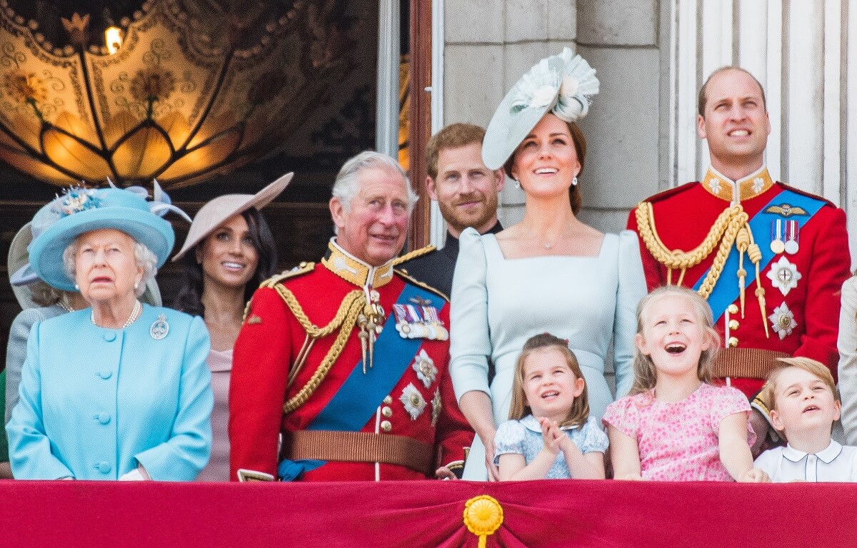 Members of the royal family including Princess Charlotte, Prince George, and Savannah Phillips, who a body language expert says is the most rebellious royal child, standing on the balcony of Buckingham Palace