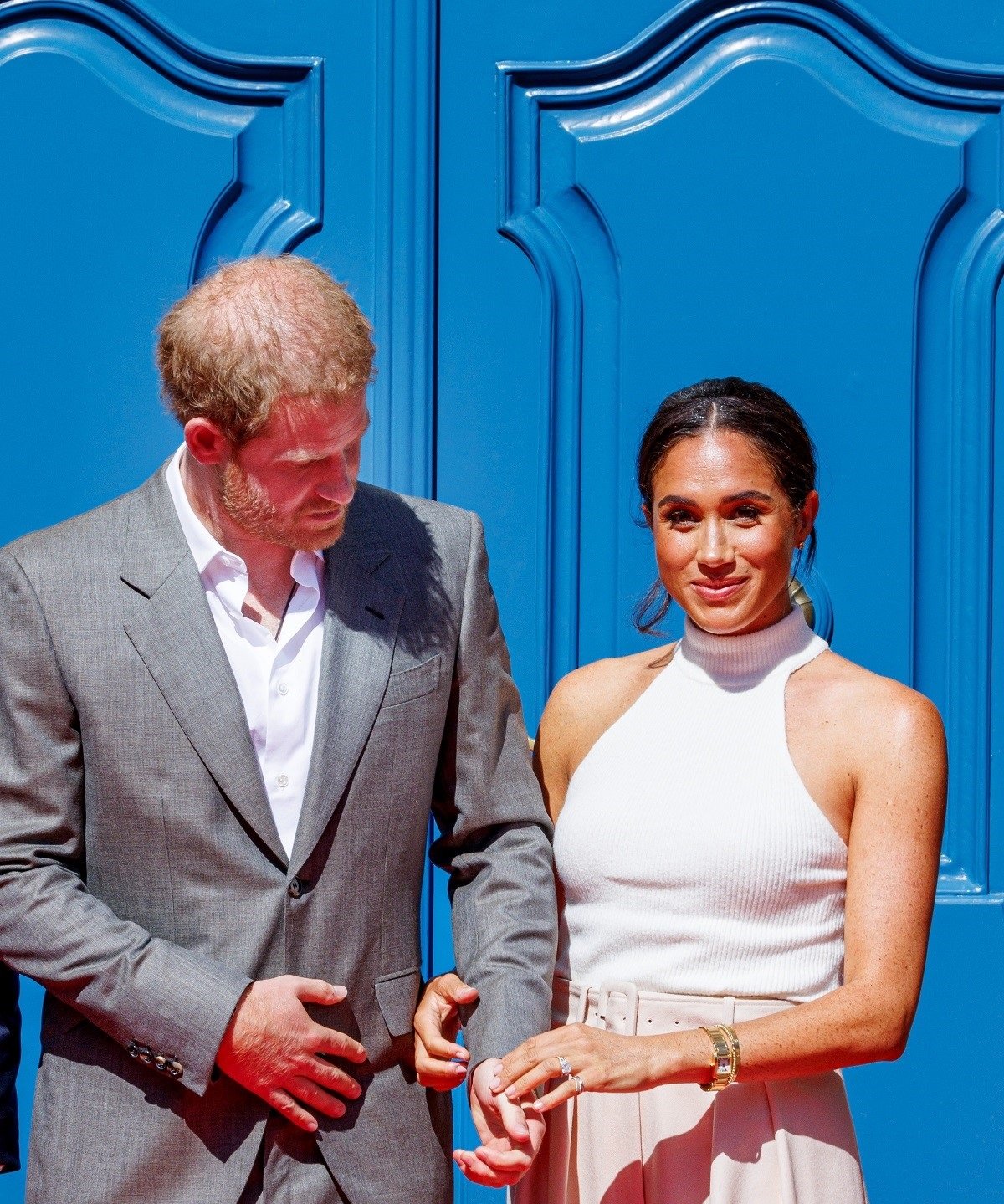 Prince Harry and Meghan Markle, who a body language expert says displayed a subtle gesture showing a change in their relationship now, visit the city hall during the Invictus Games Dusseldorf 2023