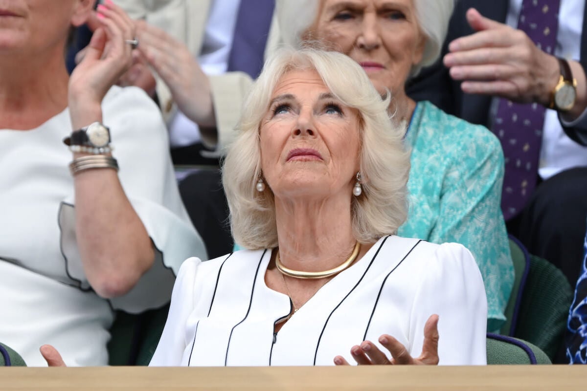 Queen Camilla, who made 'unusual' facial expressions at Wimbledon on July 12, 2023, according to a body language expert, looks up