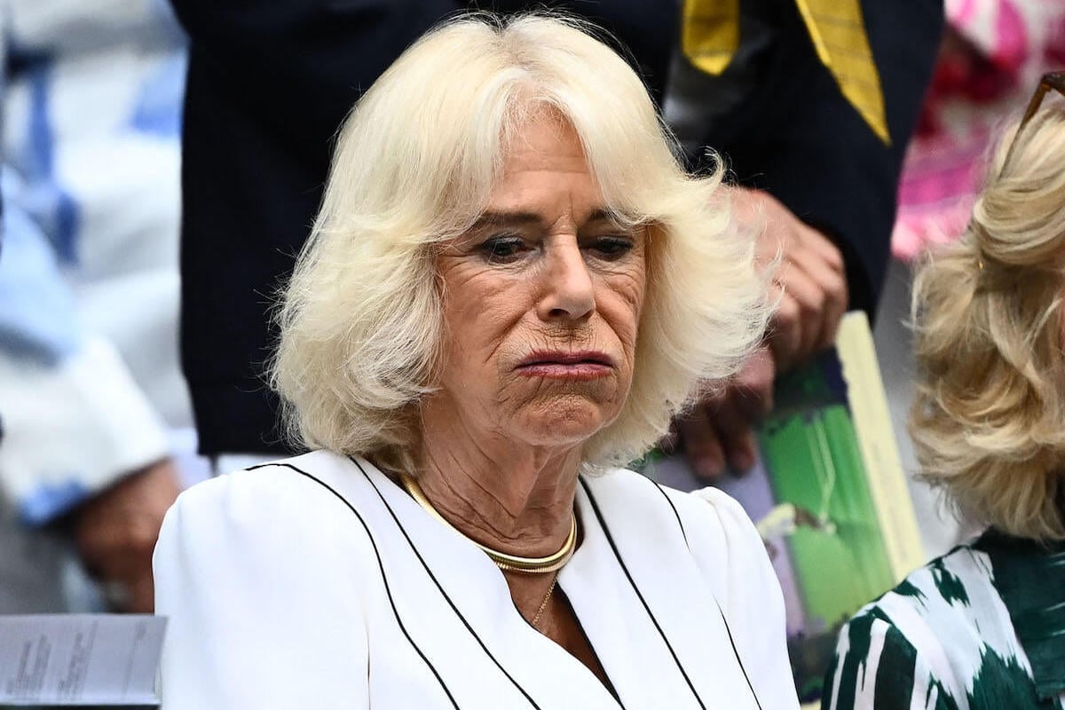 Queen Camilla, who made 'unusual' facial expressions at Wimbledon on July 12, 2023, without King Charles, accrording to a body language expert, blows air out of her mouth