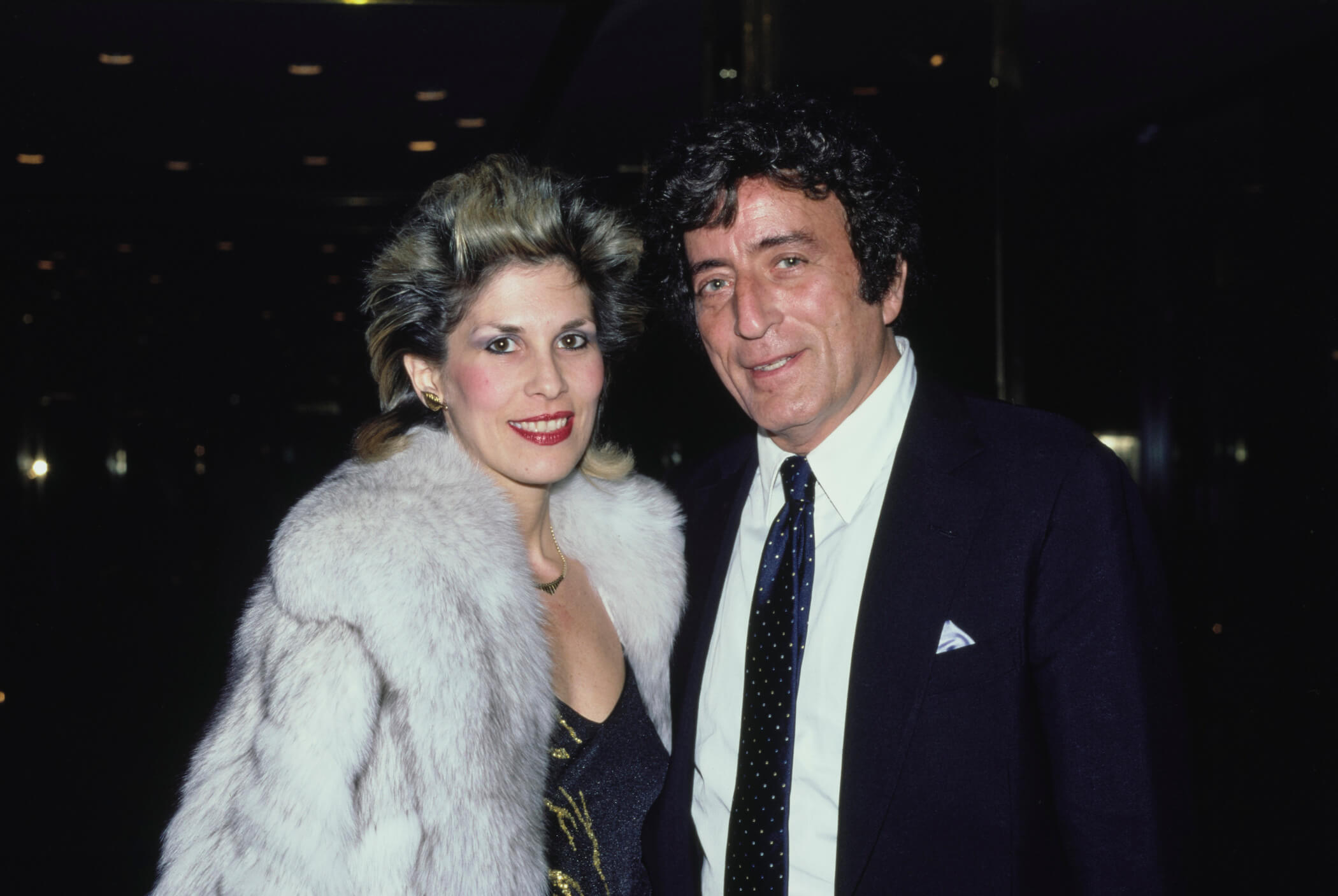 Tony Bennett and Sandra Grant standing together at night